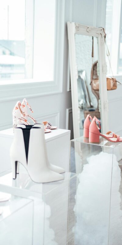 Modern shoe collection elegantly displayed in a chic boutique with natural lighting.