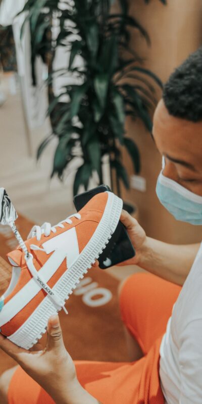 Young man in store checking out colorful sneaker, Las Vegas.